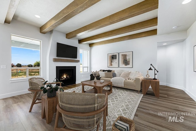 3389 E Englehart Dr, Meridian, ID 83642 - living area featuring beamed ceiling, a lit fireplace, wood finished floors, and recessed lighting