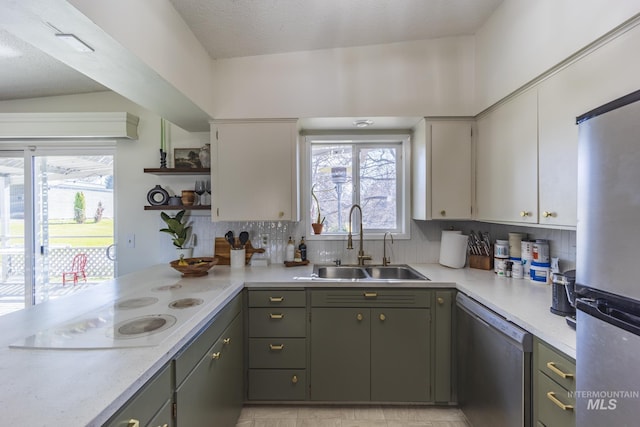 kitchen featuring a sink, tasteful backsplash, appliances with stainless steel finishes, and light countertops