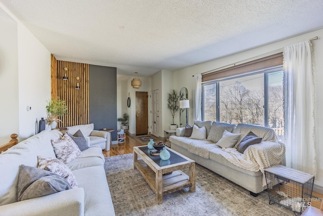 living area with a textured ceiling and wood finished floors