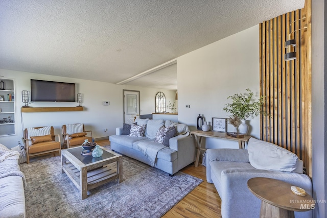 living area featuring wood finished floors and a textured ceiling