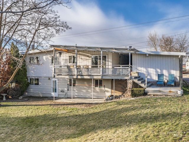 back of property with a lawn and a deck