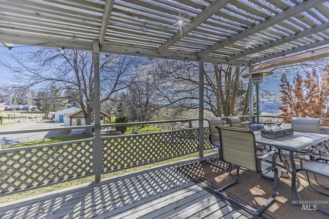 deck with outdoor dining space and a pergola