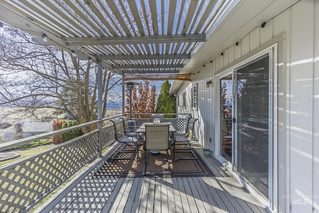 wooden terrace featuring outdoor dining space and a pergola