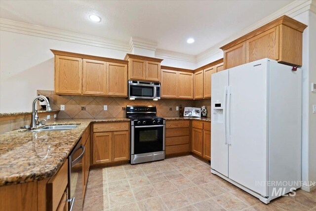 kitchen with sink, light stone counters, ornamental molding, stainless steel appliances, and decorative backsplash