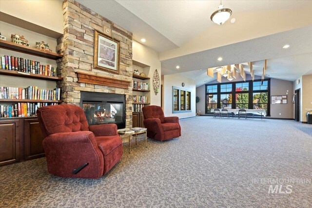 living room with dark carpet, a stone fireplace, built in shelves, and vaulted ceiling