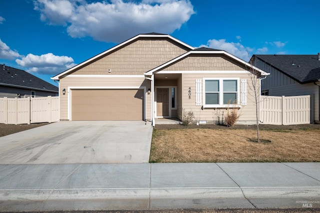 view of front facade featuring driveway, a front yard, an attached garage, and fence