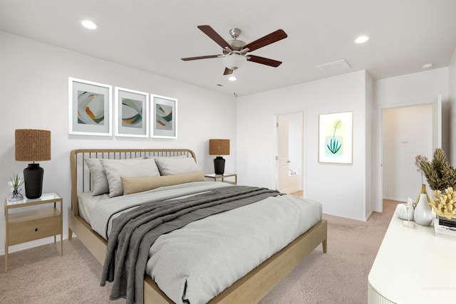 bedroom featuring baseboards, recessed lighting, a ceiling fan, light carpet, and ensuite bath