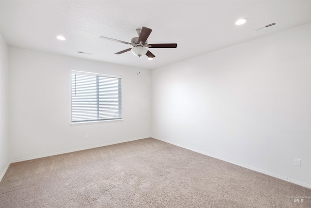 spare room featuring carpet floors, visible vents, ceiling fan, and recessed lighting