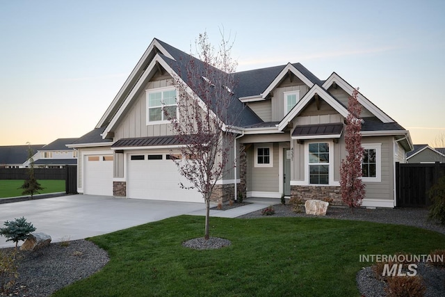 craftsman-style house with a lawn and a garage