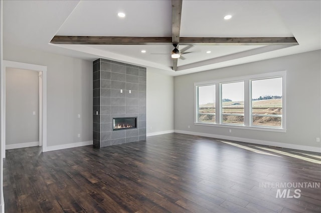 2843 E Murchison St, Meridian, ID 83642 - unfurnished living room featuring dark wood-type flooring, baseboards, a ceiling fan, recessed lighting, and beam ceiling