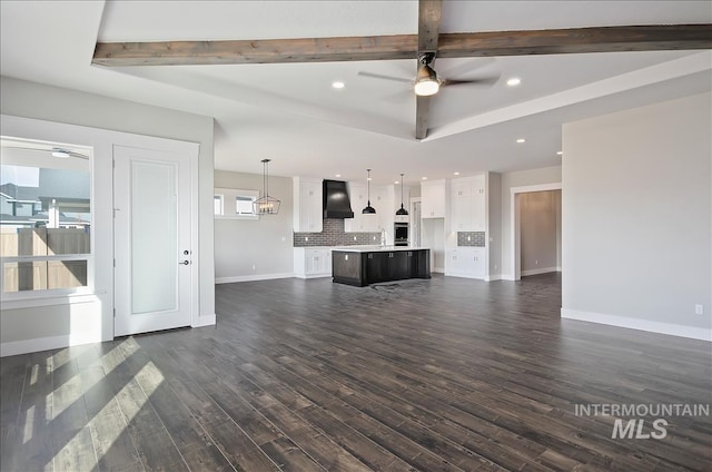 2843 E Murchison St, Meridian, ID 83642 - unfurnished living room featuring ceiling fan, dark wood finished floors, recessed lighting, baseboards, and beam ceiling