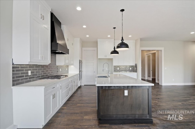 2843 E Murchison St, Meridian, ID 83642 - kitchen featuring wall chimney range hood, a sink, stainless steel appliances, tasteful backsplash, and light countertops
