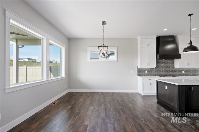 2843 E Murchison St, Meridian, ID 83642 - kitchen featuring custom exhaust hood, white cabinets, tasteful backsplash, and recessed lighting