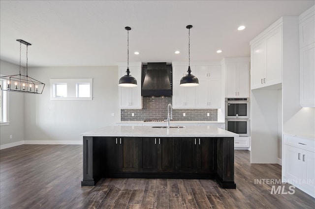 2843 E Murchison St, Meridian, ID 83642 - kitchen with premium range hood, stainless steel appliances, a sink, dark wood finished floors, and backsplash