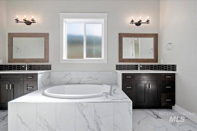2843 E Murchison St, Meridian, ID 83642 - full bathroom featuring two vanities, marble look tiles, a garden tub, and baseboards