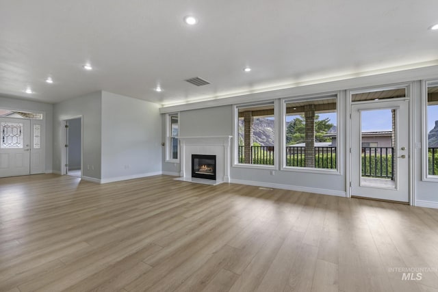 816 River View Dr, Twin Falls, ID 83301 - unfurnished living room with baseboards, visible vents, and a healthy amount of sunlight