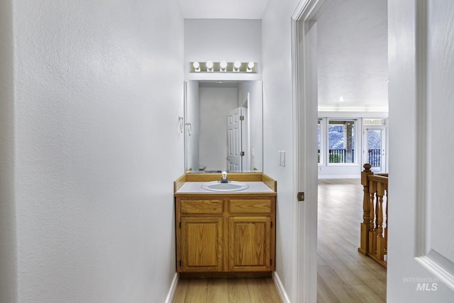 816 River View Dr, Twin Falls, ID 83301 - bathroom with baseboards, vanity, and wood finished floors