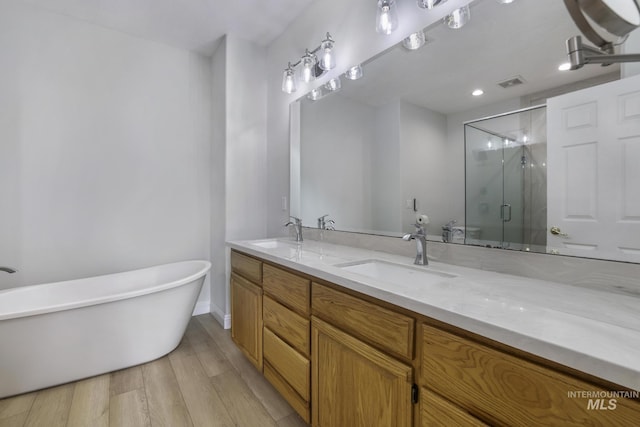 816 River View Dr, Twin Falls, ID 83301 - full bathroom featuring wood finished floors, visible vents, a sink, and double vanity