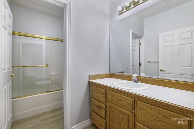 816 River View Dr, Twin Falls, ID 83301 - full bath with enclosed tub / shower combo, vanity, and wood finished floors