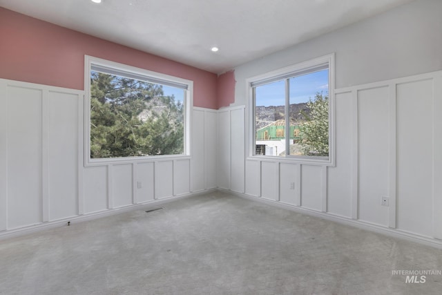 816 River View Dr, Twin Falls, ID 83301 - unfurnished room featuring a decorative wall, carpet flooring, a wainscoted wall, and recessed lighting