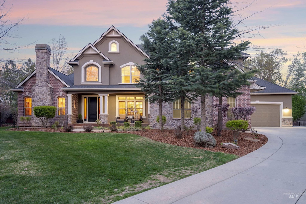 1828 N Estancia Pl, Eagle, ID 83616 - view of front of house featuring stone siding, covered porch, stucco siding, a front yard, and driveway