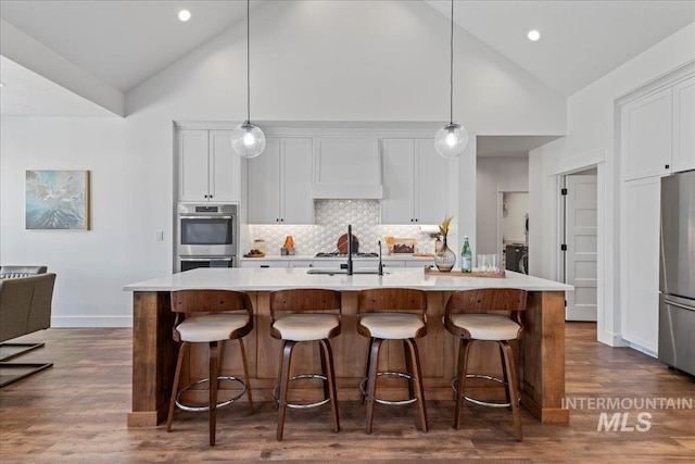 492 Applecreek St, Middleton, ID 83644 - kitchen with appliances with stainless steel finishes, high vaulted ceiling, light countertops, dark wood-style floors, and white cabinetry