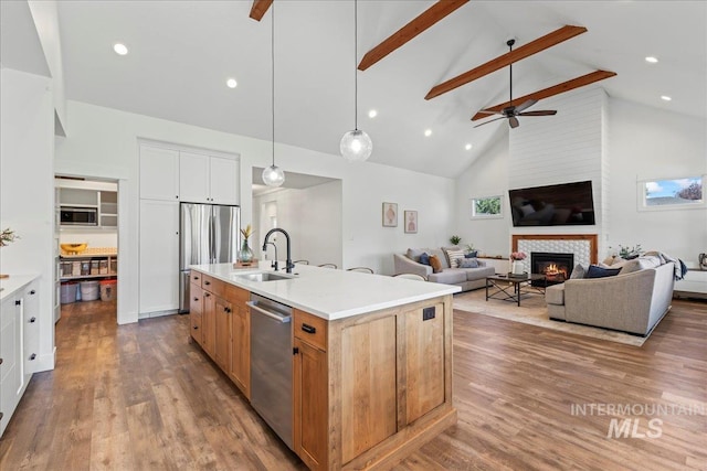 492 Applecreek St, Middleton, ID 83644 - kitchen with appliances with stainless steel finishes, high vaulted ceiling, ceiling fan, beam ceiling, and a glass covered fireplace