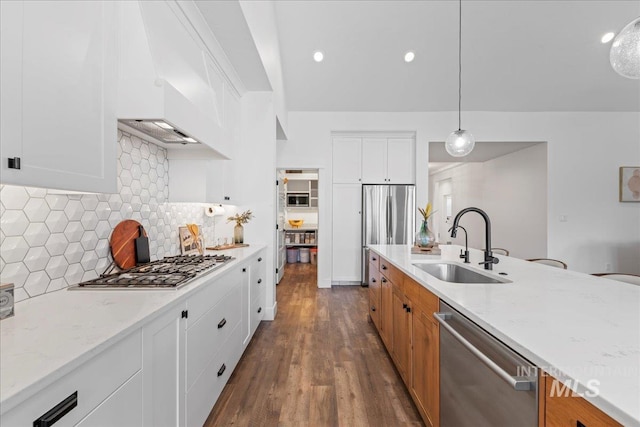 492 Applecreek St, Middleton, ID 83644 - kitchen featuring appliances with stainless steel finishes, dark wood-type flooring, light stone counters, tasteful backsplash, and white cabinetry