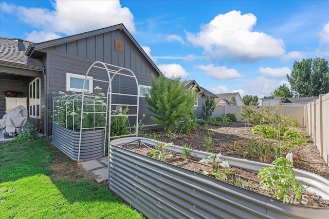 492 Applecreek St, Middleton, ID 83644 - view of side of property with board and batten siding, a garden, and a fenced backyard