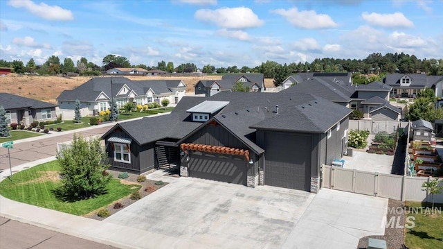 492 Applecreek St, Middleton, ID 83644 - view of front of house featuring a residential view, a gate, board and batten siding, stone siding, and a garage