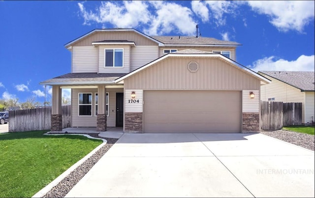 view of front of property with a garage, a front yard, and covered porch