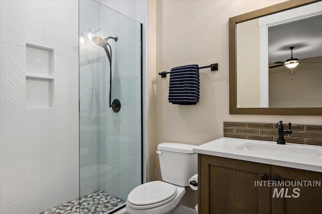 9351 W Sooty Grouse Ct, Boise, ID 83714 - bathroom with vanity, toilet, decorative backsplash, a stall shower, and a ceiling fan