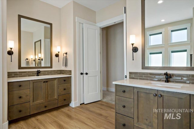 9351 W Sooty Grouse Ct, Boise, ID 83714 - full bathroom featuring backsplash, two vanities, wood finished floors, baseboards, and recessed lighting