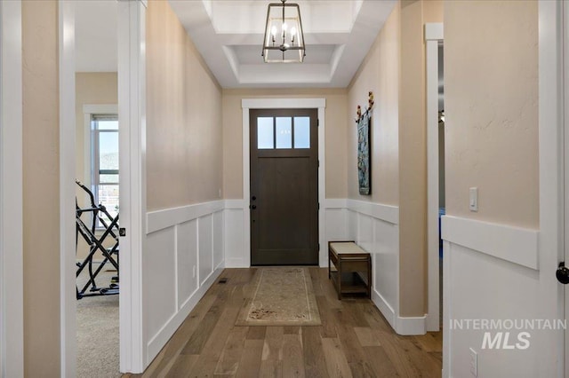 9351 W Sooty Grouse Ct, Boise, ID 83714 - foyer featuring wood finished floors, a wainscoted wall, a chandelier, and a decorative wall