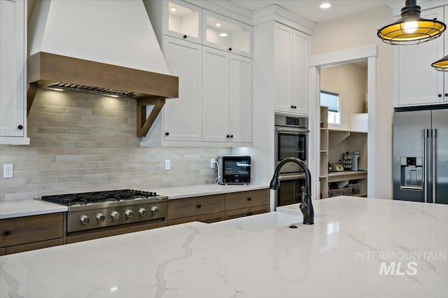9351 W Sooty Grouse Ct, Boise, ID 83714 - kitchen featuring wall chimney exhaust hood, high quality fridge, gas cooktop, a sink, and white cabinets