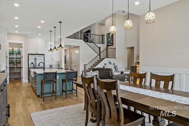 9351 W Sooty Grouse Ct, Boise, ID 83714 - dining room featuring light wood-type flooring, recessed lighting, and stairway