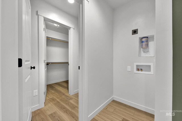 laundry area featuring hookup for an electric dryer, baseboards, light wood-style flooring, laundry area, and washer hookup