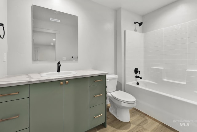 full bath featuring vanity, toilet, visible vents,  shower combination, and wood finished floors