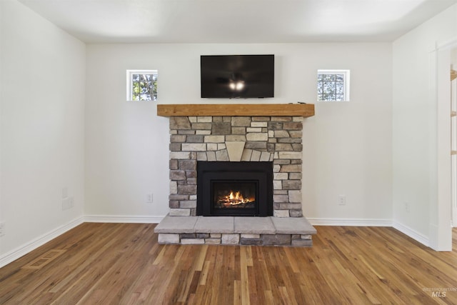 608 S Eagleson Rd, Boise, ID 83705 - detailed view of a stone fireplace, wood finished floors, and baseboards