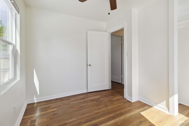 608 S Eagleson Rd, Boise, ID 83705 - unfurnished bedroom with wood finished floors, multiple windows, and baseboards