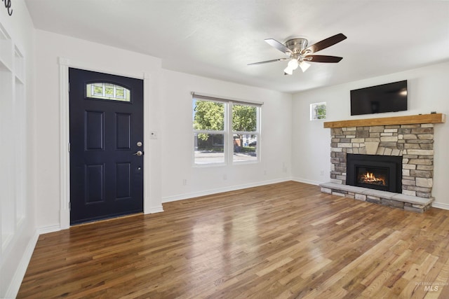 608 S Eagleson Rd, Boise, ID 83705 - foyer entrance with wood finished floors, a ceiling fan, a stone fireplace, and baseboards