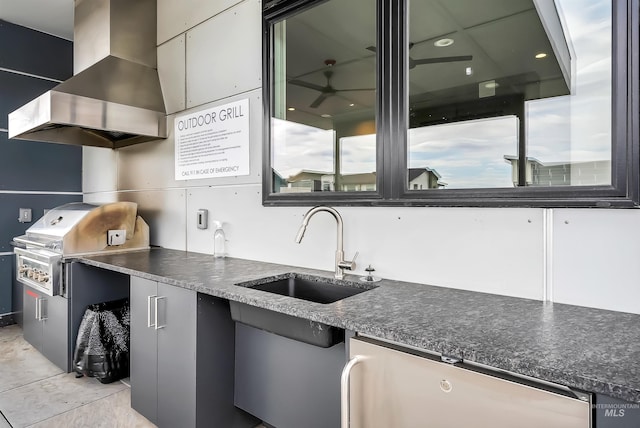 3850 E Haystack St Unit 205, Boise, ID 83716 - kitchen featuring wall chimney range hood, dark countertops, dishwashing machine, and ceiling fan