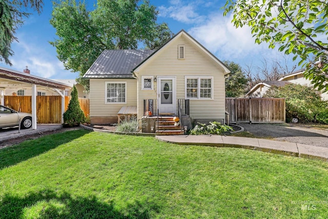 bungalow-style home with a front yard