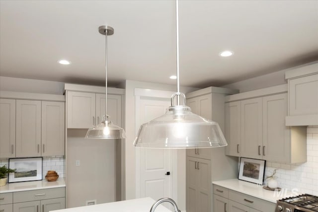 kitchen featuring pendant lighting, gray cabinetry, recessed lighting, light countertops, and decorative backsplash