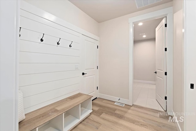 mudroom with recessed lighting, visible vents, baseboards, and light wood-style floors