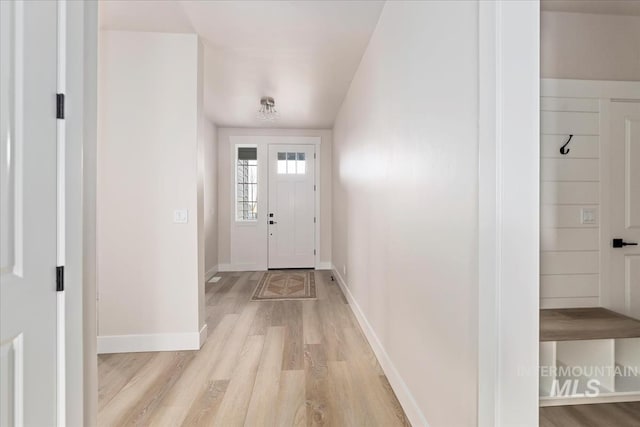 foyer with light wood-type flooring and baseboards