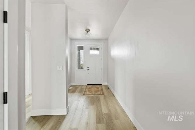 entrance foyer with light wood finished floors and baseboards