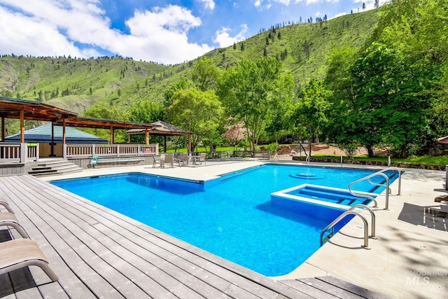 view of swimming pool featuring a deck with mountain view