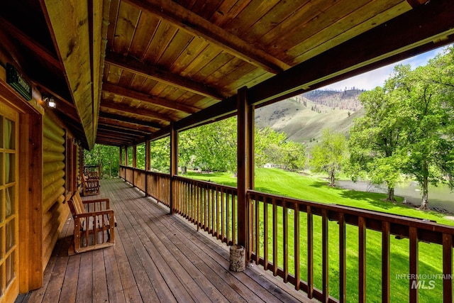 wooden terrace with a yard