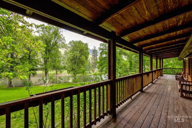 wooden terrace with a lawn